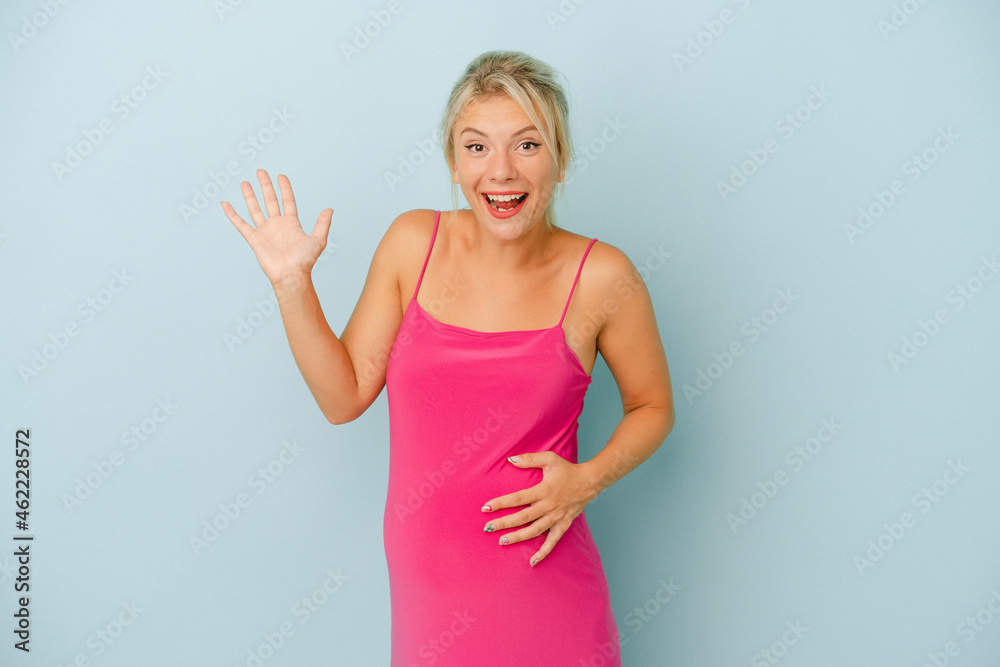 Young Russian woman pregnant isolated on blue background receiving a pleasant surprise, excited and raising hands. Young Russian woman pregnant isolated on blue background receiving a pleasant surprise, excited and raising hands.