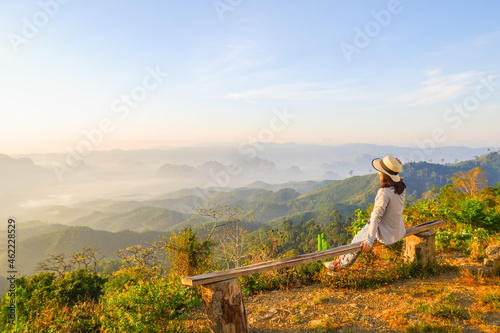 Wallpaper Mural young asia woman feeling happy wearing hat resting on tropical mountain at Doi Ta Pang (khao thalu) travel in chumphon thailand Torontodigital.ca