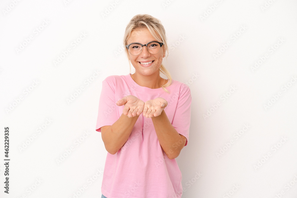 Young Russian woman isolated on white background holding something with palms, offering to camera. Young Russian woman isolated on white background holding something with palms, offering to camera.
