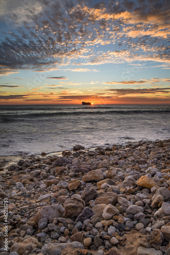 Sunset on the beach on the coast of France over the Atlantic Ocean, sea landscape. Plage de Pen Hat in France. © Kozioł Kamila