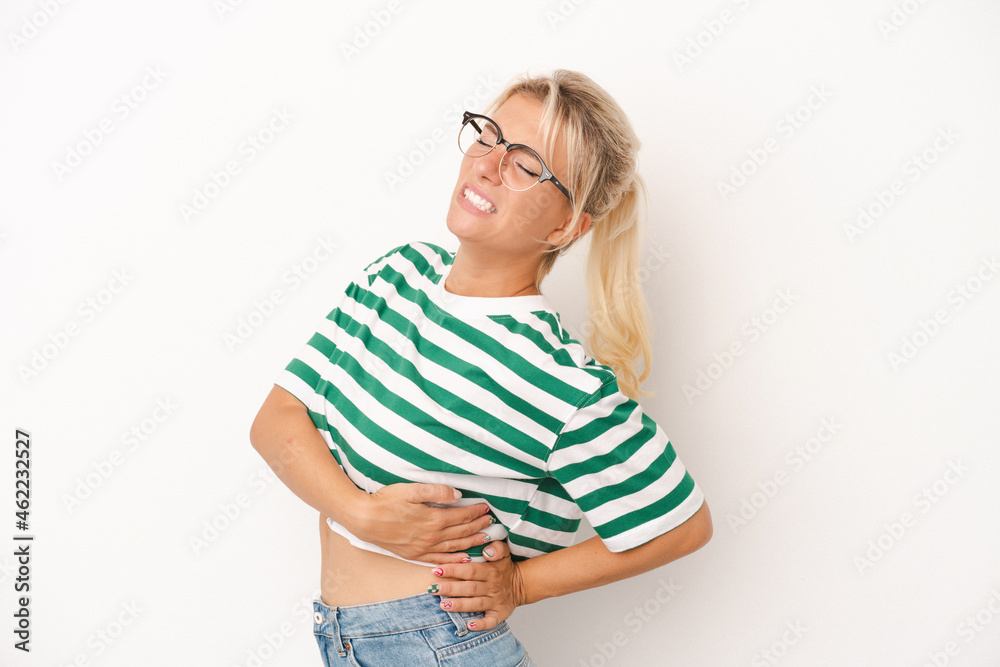 Young Russian woman isolated on white background suffering a back pain. Young Russian woman isolated on white background suffering a back pain.