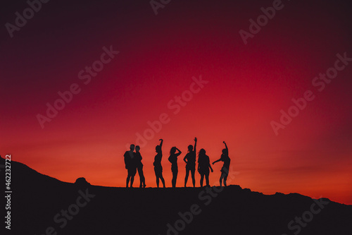 Sky with sunset or sunrise and silhouette of group people