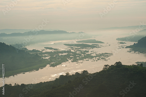 large river flows through the mountains at dawn.