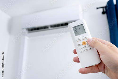 Air conditioning system, remote control in hand