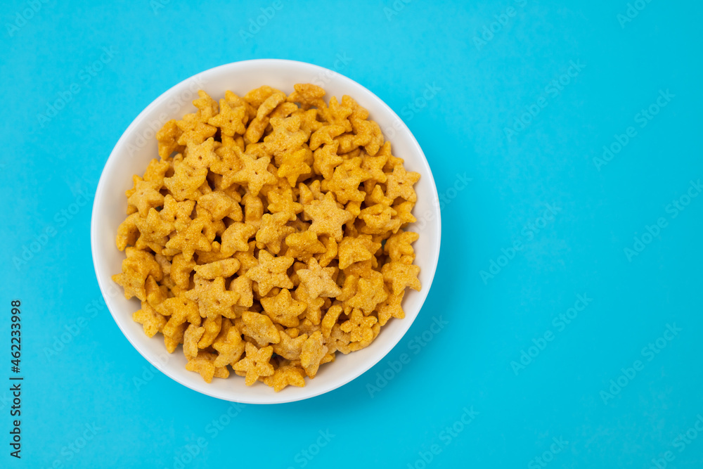 sweet yellow corn flakes in white small bowl sweet yellow corn flakes in white small bowl