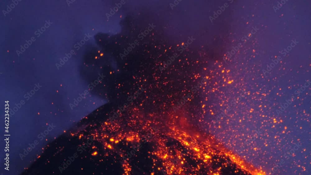 Volcan de fuego erupting by night lava and rocks