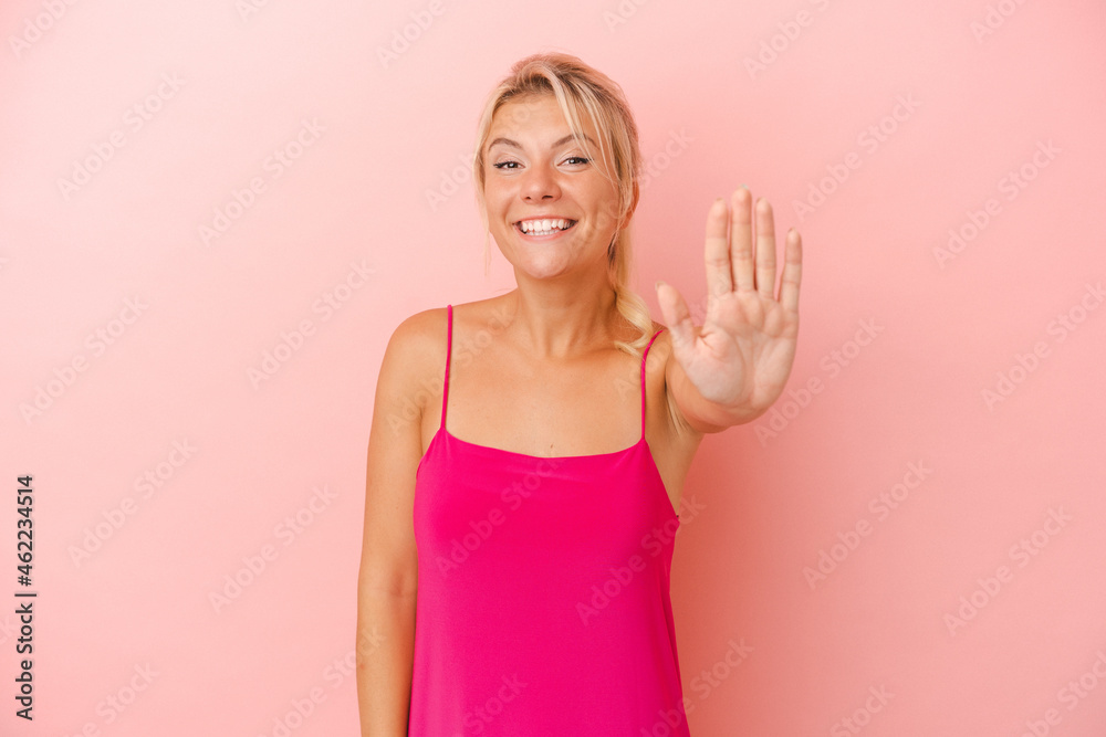 Young Russian woman isolated on pink background smiling cheerful showing number five with fingers. Young Russian woman isolated on pink background smiling cheerful showing number five with fingers.