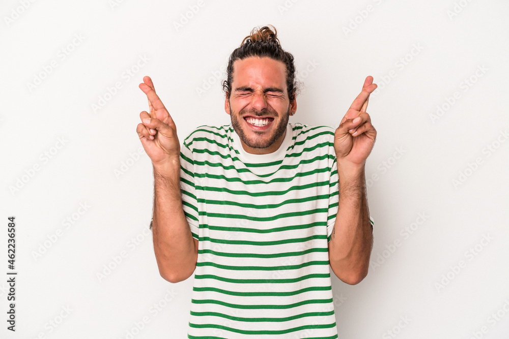 Young caucasian man isolated on white background crossing fingers for having luck Young caucasian man isolated on white background crossing fingers for having luck