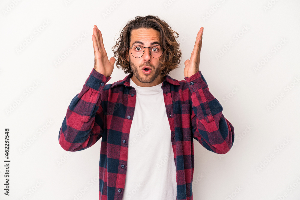 Young caucasian man isolated on white background surprised and shocked. Young caucasian man isolated on white background surprised and shocked.