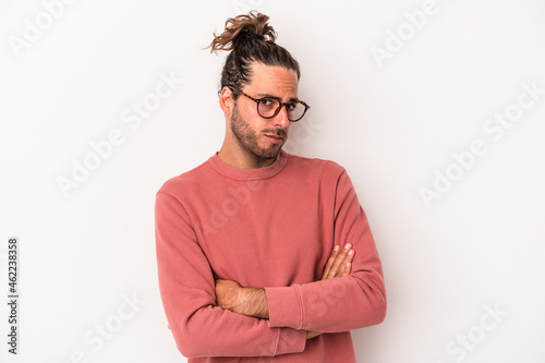 Young caucasian man isolated on white background unhappy looking in camera with sarcastic expression. © Asier