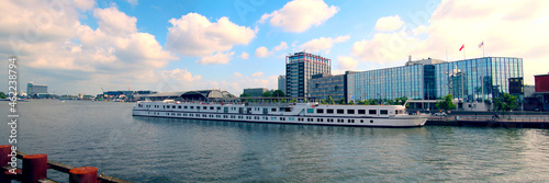 River cruise ship at dock near the main station in the city center of Amsterdam (Netherlands)