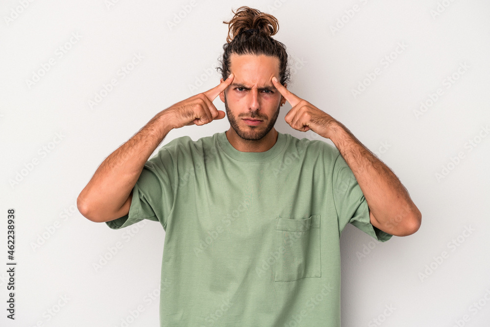 Young caucasian man isolated on gray background focused on a task, keeping forefingers pointing head. Young caucasian man isolated on gray background focused on a task, keeping forefingers pointing head.