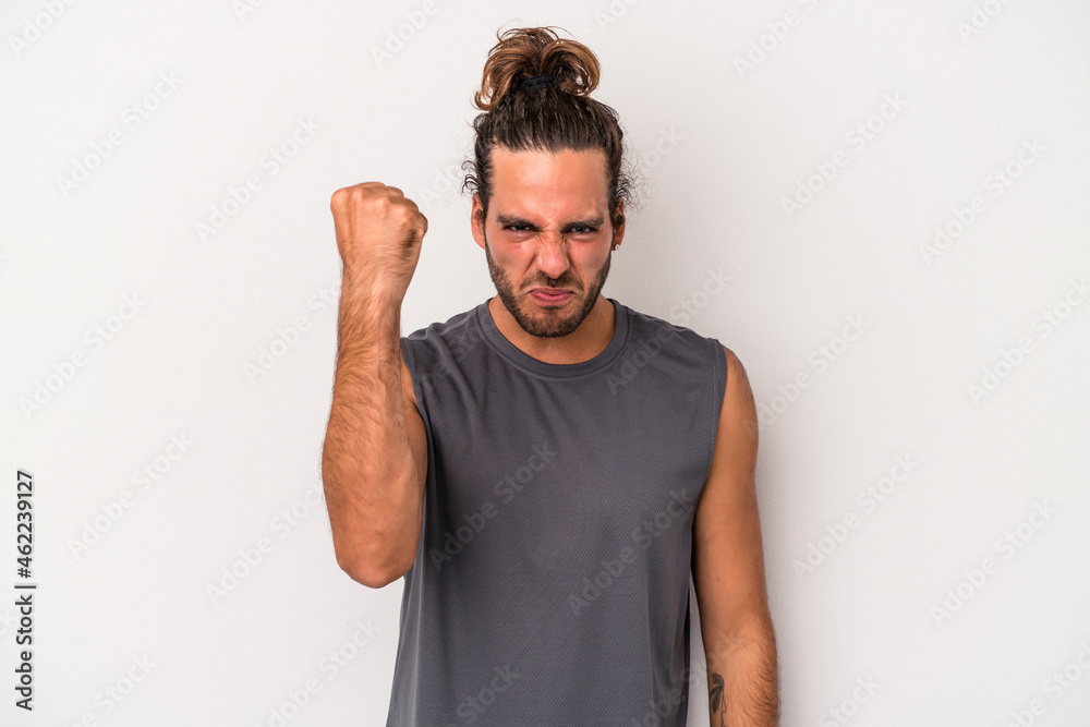 Young caucasian man isolated on gray background showing fist to camera, aggressive facial expression. Young caucasian man isolated on gray background showing fist to camera, aggressive facial expression.