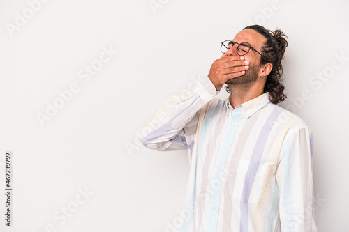 Young caucasian man isolated on gray background laughing happy, carefree, natural emotion.