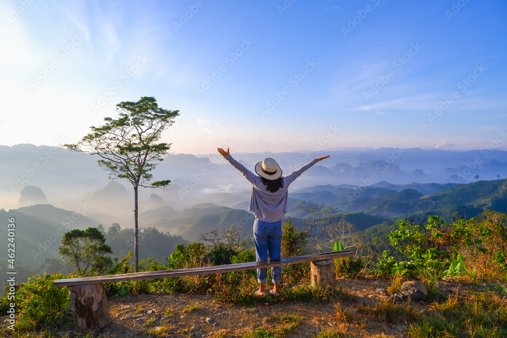 young asia woman feeling happy wearing hat resting on tropical mountain at Doi Ta Pang (khao thalu) travel in chumphon thailand young asia woman feeling happy wearing hat resting on tropical mountain at Doi Ta Pang (khao thalu) travel in chumphon thailand