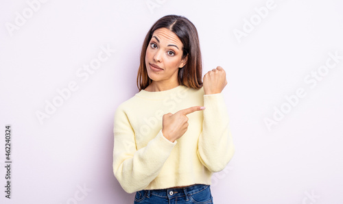pretty hispanic woman looking impatient and angry, pointing at watch, asking for punctuality, wants to be on time