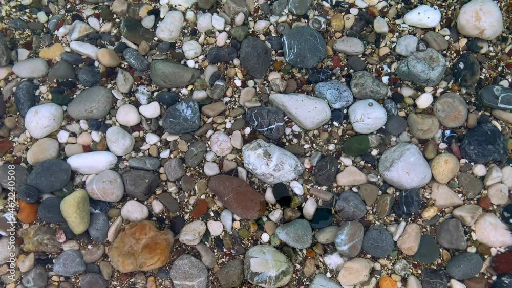 Pebble stones on the shore transparent blue sea water close up summer vacation concept Pebble stones on the shore transparent blue sea water close up summer vacation concept