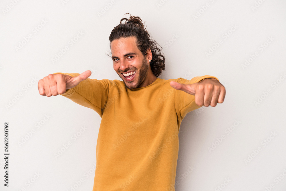 Young caucasian man isolated on gray background raising both thumbs up, smiling and confident.