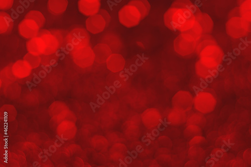 Red sparkling glitter bokeh background, christmas abstract defocused texture. Holiday lights
