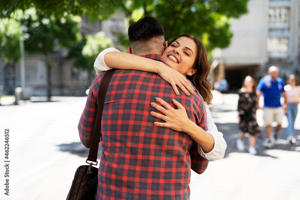 Happy young couple in the city. Loving couple hugging outdoors Happy young couple in the city. Loving couple hugging outdoors