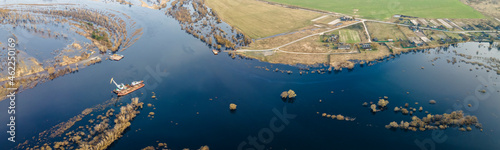 Aerial view of dredge replenish sand in river. Canal is being dredged by excavator. Top view of dredging boat crane.