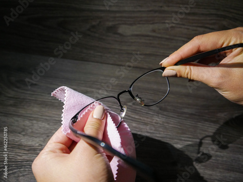 glasses for vision, girl wipes glasses, vision care
