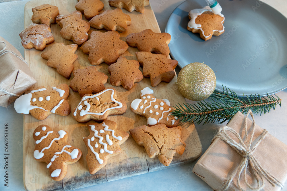 Children's hands make New Year's gingerbread cookies on a wooden table. Making cookies with a cookie cutter. New Year and Christmas concept.