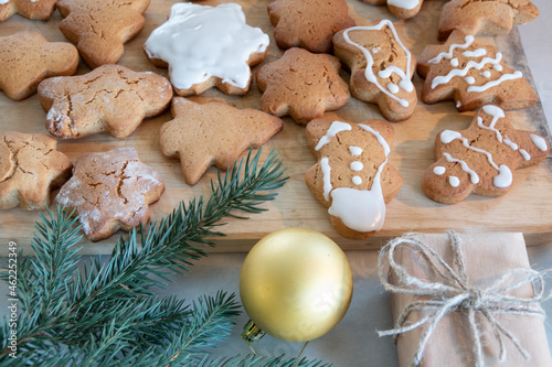 Children's hands make New Year's gingerbread cookies on a wooden table. Making cookies with a cookie cutter. New Year and Christmas concept.