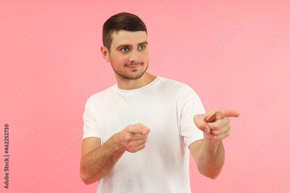 Young man in white t-shirt on pink background Young man in white t-shirt on pink background