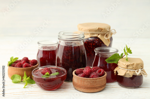 Concept of tasty food with raspberry jam on wooden table