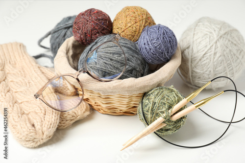 Knitting concept with yarn balls on white background