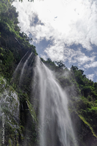 Portrait shot of waterfall against the sky