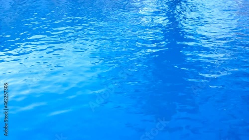 pool water slightly moved by the wind. blue background