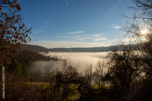 Beautiful scenic winter landscape with a fog filled valley