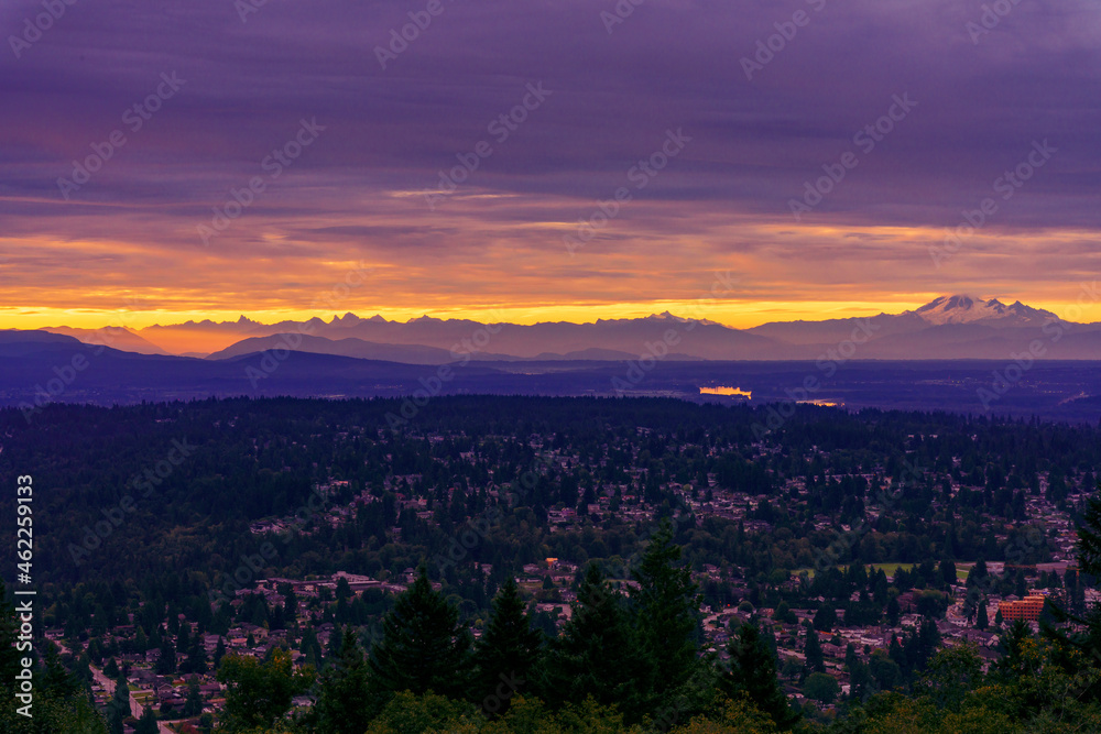 Fototapeta premium Sunrise over valley and distant alpine mountains, BC, Canada.