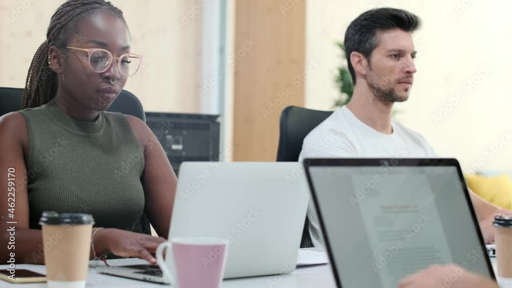 Video of multiethnic businesspeople working with computers in a coworking place. Video of multiethnic businesspeople working with computers in a coworking place.