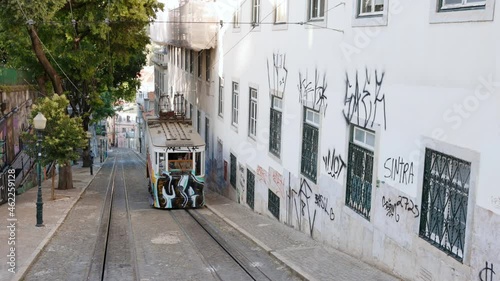 Cable car rides up street in Bairro Alto photo