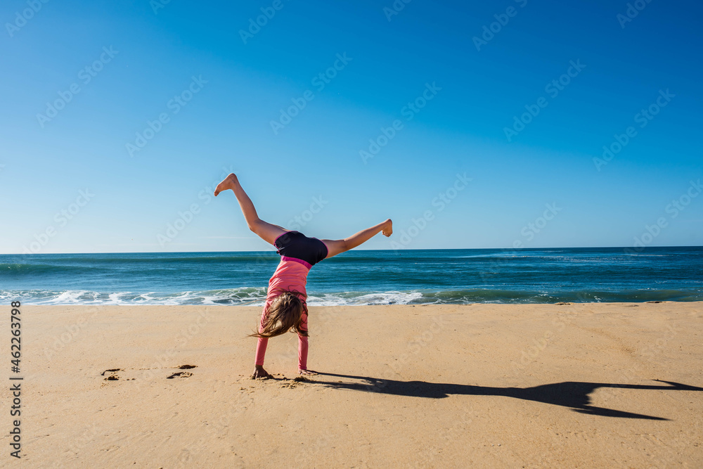 cute young girl running and jumping on sunny beach cute young girl running and jumping on sunny beach
