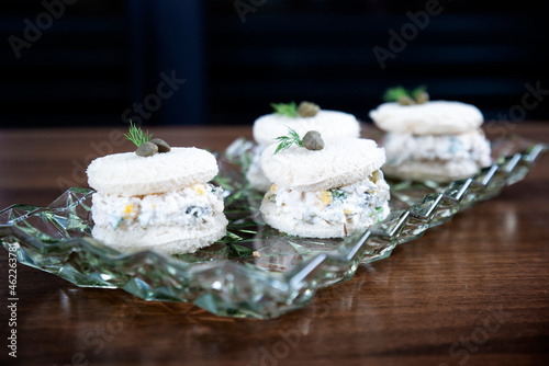 Chicken sandwich with garnitures and caesar sauce on glass plate photo