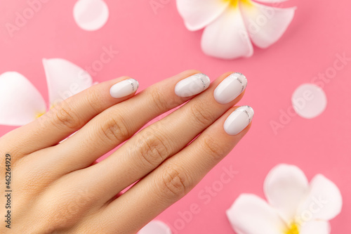 Womans hands with trendy white french manicure