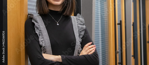 a woman in the office wearing a long-sleeved black t-shirt