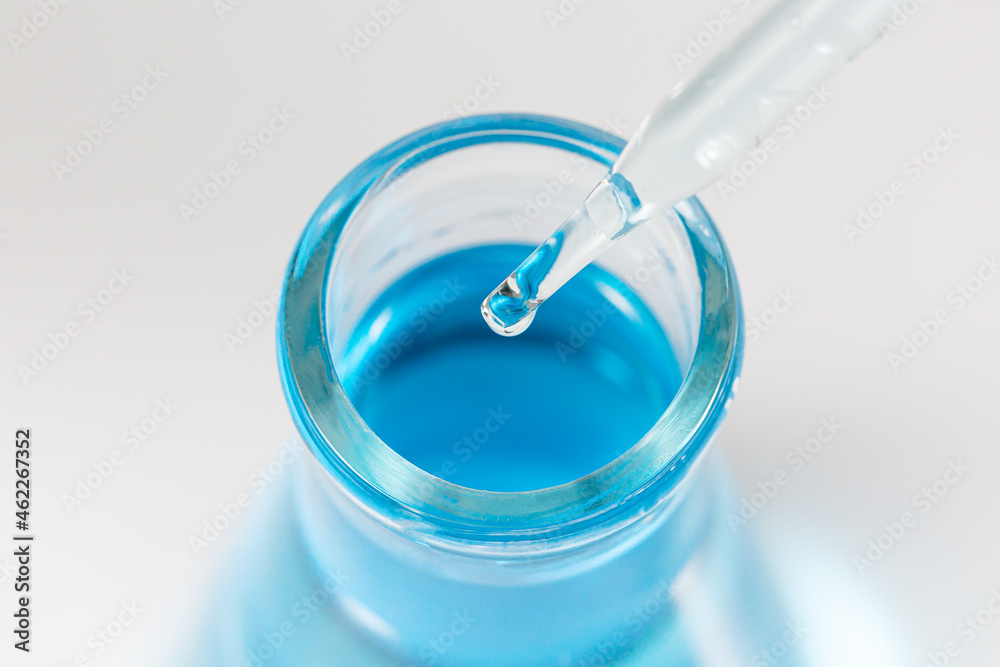 hand of scientist holding flask with lab glassware and test tubes in chemical laboratory background, science laboratory research and development concept hand of scientist holding flask with lab glassware and test tubes in chemical laboratory background, science laboratory research and development concept
