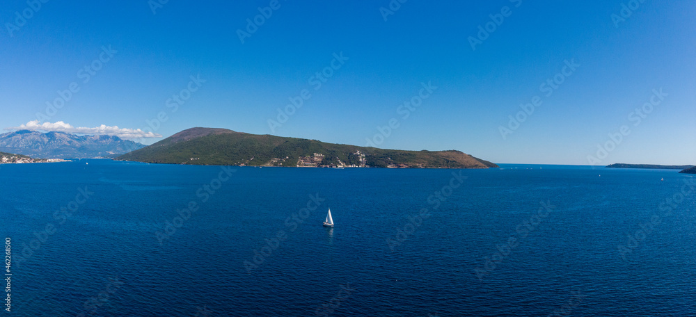 Sailing yacht sails along Bay of Kotor in Montenegro,Adriatic sea. Sailing yacht sails along Bay of Kotor in Montenegro,Adriatic sea.