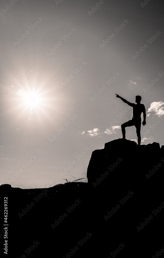 silhouette of a person on the top of mountain