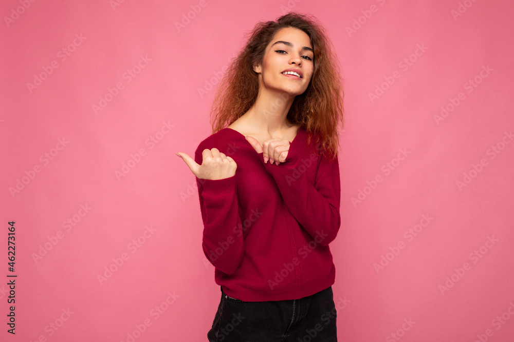 Portrait of beautiful fascinating emotional positive joyful happpy female promoter pointing to the side at copy space for advertising wearing hipster outfit isolated over background wall with empty Portrait of beautiful fascinating emotional positive joyful happpy female promoter pointing to the side at copy space for advertising wearing hipster outfit isolated over background wall with empty
