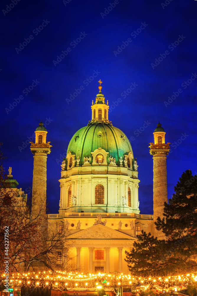 Festive cityscape - view of the Karlskirche (St. Charles Church) and the Christmas Market on Karlsplatz (Charles' Square) in the city of Vienna, Austria