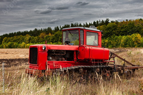crawler tractor standing in a field on arable land