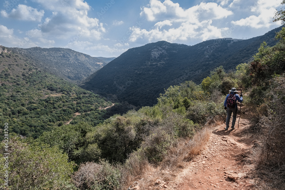 A female hiker hiking on the scenic trail to Ein Tamir Spring in Kziv stream, Montfort  Nahal Kziv National park, Northern District of Israel, Israel.  