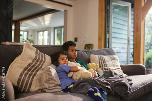 Two boys watching TV on sofa