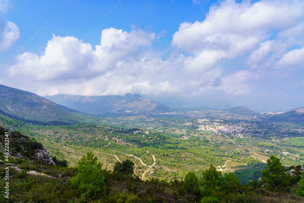Green landscape panorama of the valley with small villages of white houses. Alicante Spain.